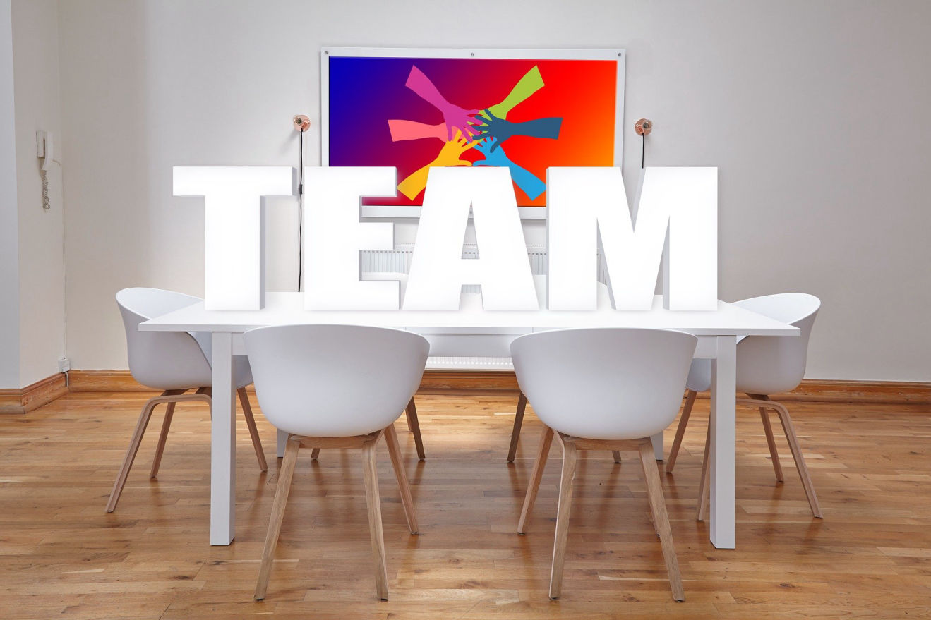 The word Team spelled out and sitting on top of a white table